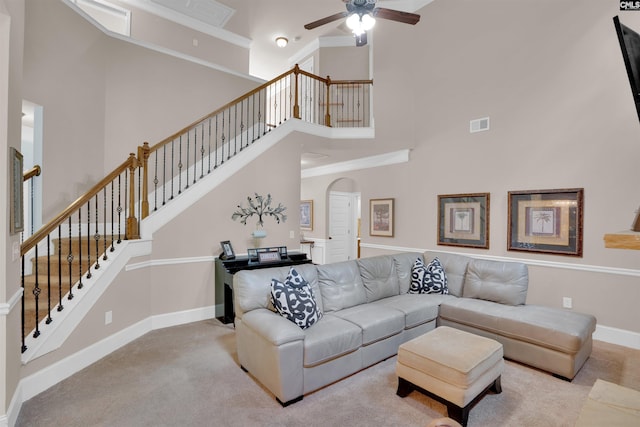 699 Village Market Dr, Chapin, SC 29036 - carpeted living area with a high ceiling, arched walkways, ceiling fan, and stairs