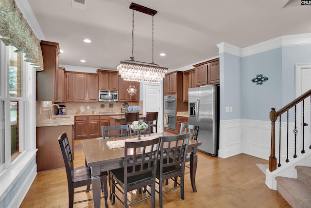 699 Village Market Dr, Chapin, SC 29036 - dining area featuring stairs, light wood finished floors, wainscoting, recessed lighting, and crown molding