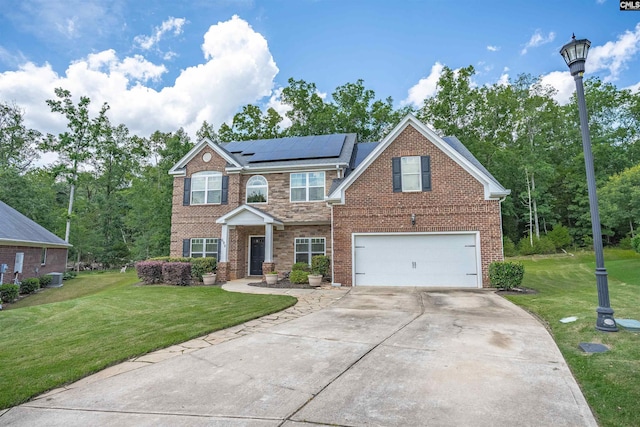 699 Village Market Dr, Chapin, SC 29036 - view of front of home with concrete driveway, an attached garage, roof mounted solar panels, and a front lawn
