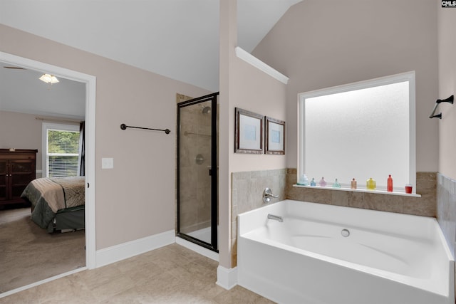 699 Village Market Dr, Chapin, SC 29036 - bathroom with a bath, a stall shower, lofted ceiling, ensuite bathroom, and tile patterned flooring