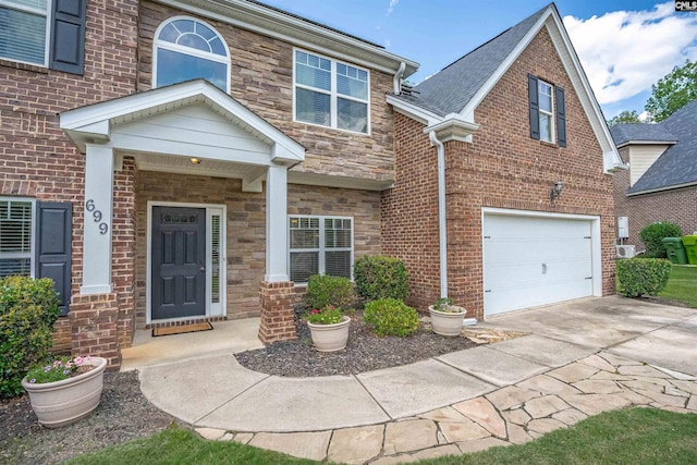 699 Village Market Dr, Chapin, SC 29036 - view of front of home featuring an attached garage, concrete driveway, stone siding, and brick siding