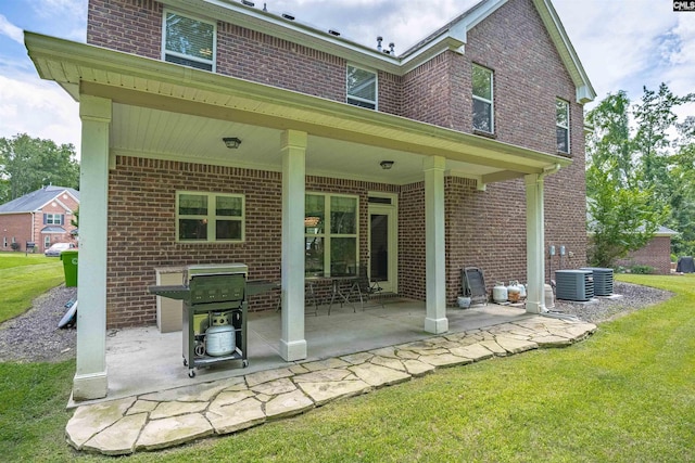 699 Village Market Dr, Chapin, SC 29036 - rear view of property featuring brick siding, a patio, and a lawn