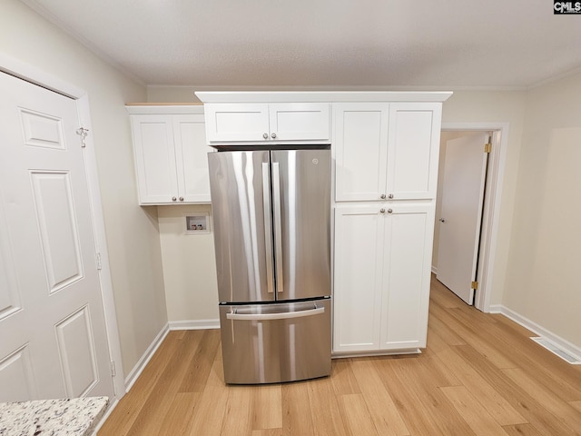 1712 Omarest Dr, Columbia, SC 29210 - kitchen with freestanding refrigerator, light wood-style floors, white cabinets, and crown molding