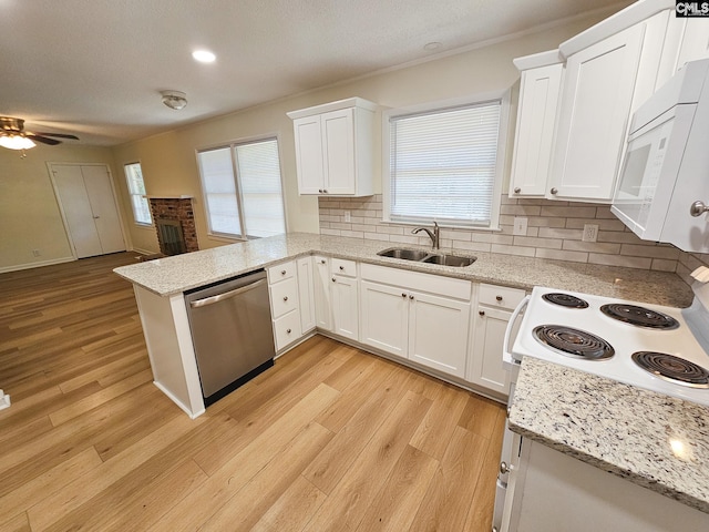 1712 Omarest Dr, Columbia, SC 29210 - kitchen with white microwave, dishwasher, a peninsula, and light wood-type flooring