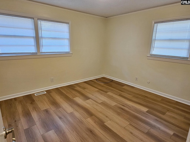 1712 Omarest Dr, Columbia, SC 29210 - spare room featuring crown molding, wood finished floors, and healthy amount of natural light