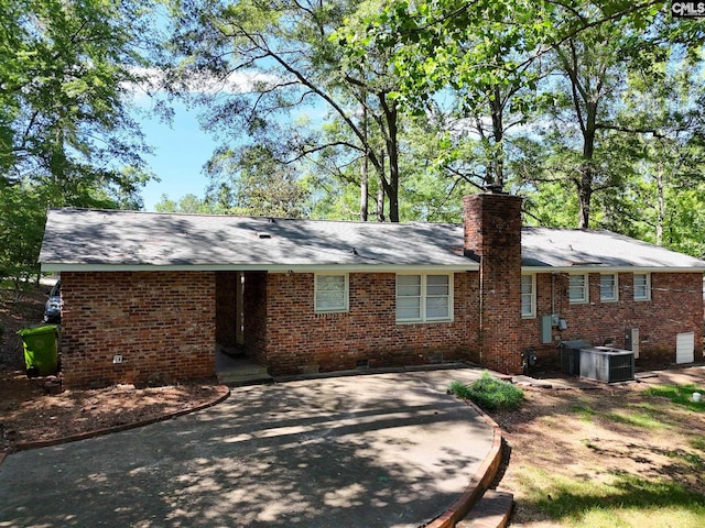 1712 Omarest Dr, Columbia, SC 29210 - view of front of property with crawl space, a chimney, brick siding, a patio area, and driveway