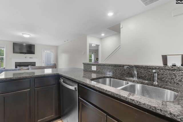 465 Vanburen Ct, Gaston, SC 29053 - kitchen with stainless steel dishwasher, dark stone counters, a fireplace, and open floor plan