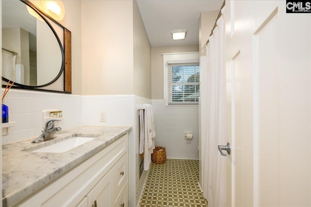 3139 Travis Ct, Columbia, SC 29204 - full bath featuring tile walls, vanity, tile patterned floors, and a wainscoted wall