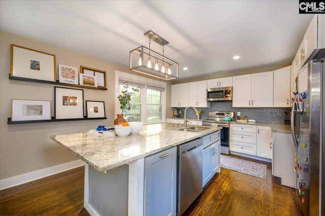 3139 Travis Ct, Columbia, SC 29204 - kitchen with stainless steel appliances, dark wood-style flooring, white cabinetry, light stone counters, and recessed lighting