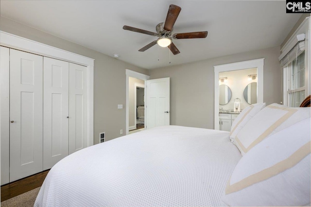 3139 Travis Ct, Columbia, SC 29204 - bedroom featuring a closet, dark wood-style floors, a ceiling fan, and connected bathroom