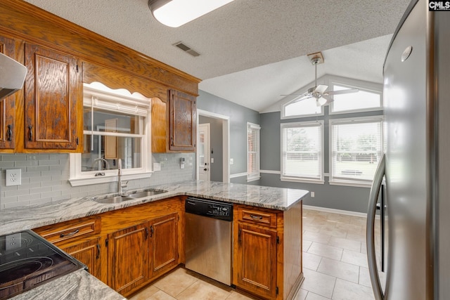 40 Stonehedge Ct, Sumter, SC 29154 - kitchen featuring stainless steel appliances, ceiling fan, a peninsula, decorative backsplash, and light tile patterned flooring