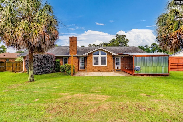 40 Stonehedge Ct, Sumter, SC 29154 - back of house with a chimney, a patio area, and brick siding