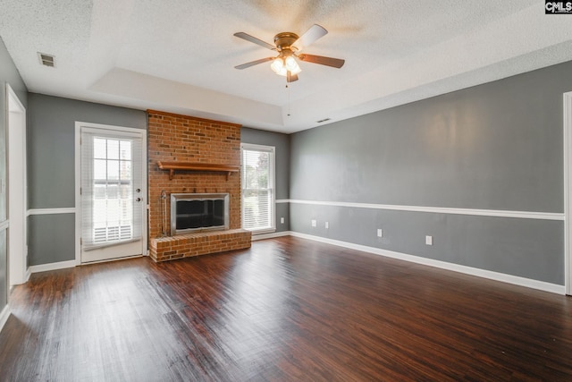40 Stonehedge Ct, Sumter, SC 29154 - unfurnished living room featuring healthy amount of natural light, a ceiling fan, wood finished floors, a brick fireplace, and a textured ceiling