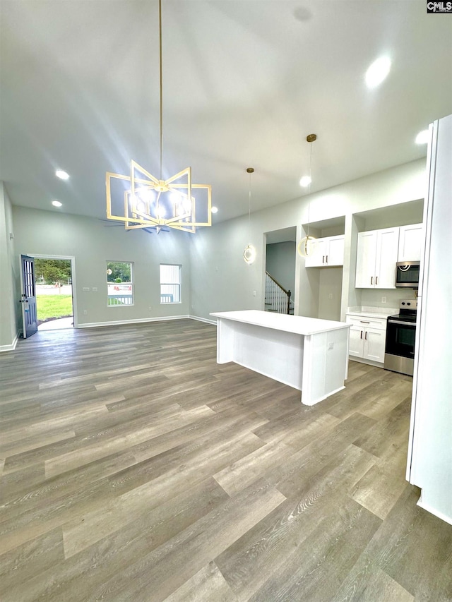 10 Lincolnshire Ct, Columbia, SC 29203 - kitchen with stainless steel appliances, open floor plan, white cabinets, light wood-style floors, and decorative light fixtures
