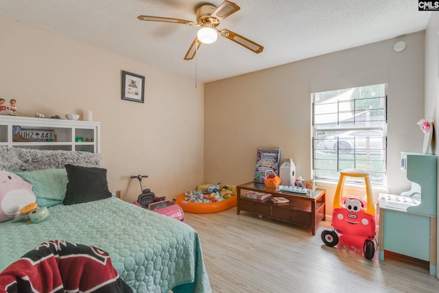 255 Sunnydale Dr, Columbia, SC 29223 - bedroom featuring wood finished floors, multiple windows, a ceiling fan, and a textured ceiling