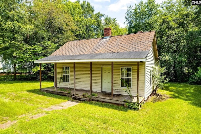 2120 Pleasant Rdg, Camden, SC 29020 - view of front of home featuring a porch, a front yard, a chimney, and roof with shingles
