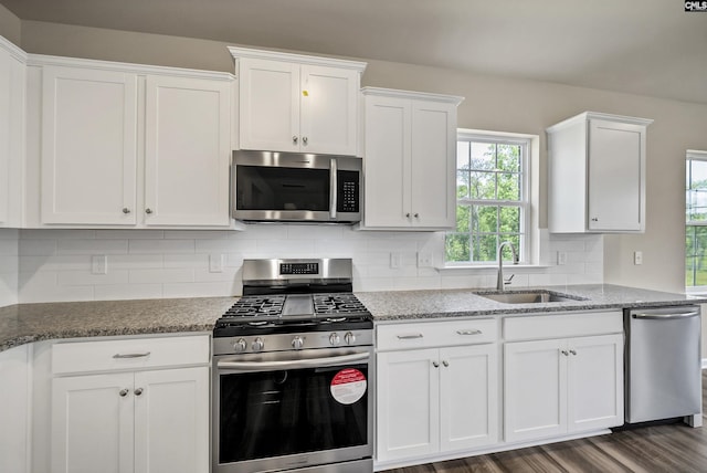 259 Backspin Dr, Elgin, SC 29045 - kitchen with stainless steel appliances, white cabinets, decorative backsplash, light stone counters, and dark wood-style floors