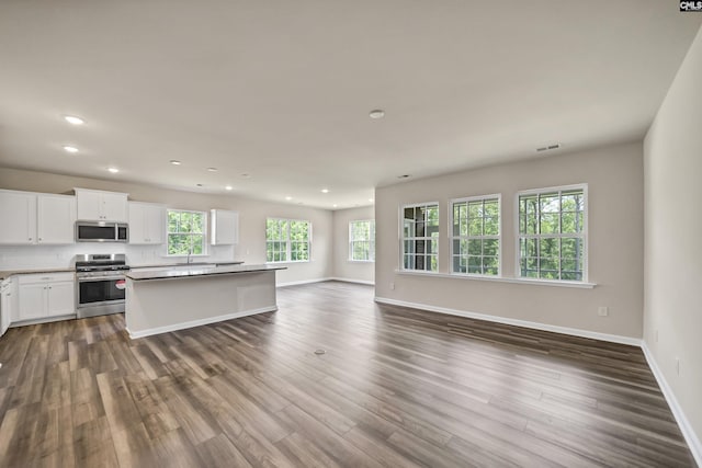 259 Backspin Dr, Elgin, SC 29045 - kitchen with appliances with stainless steel finishes, dark wood-type flooring, recessed lighting, open floor plan, and a center island