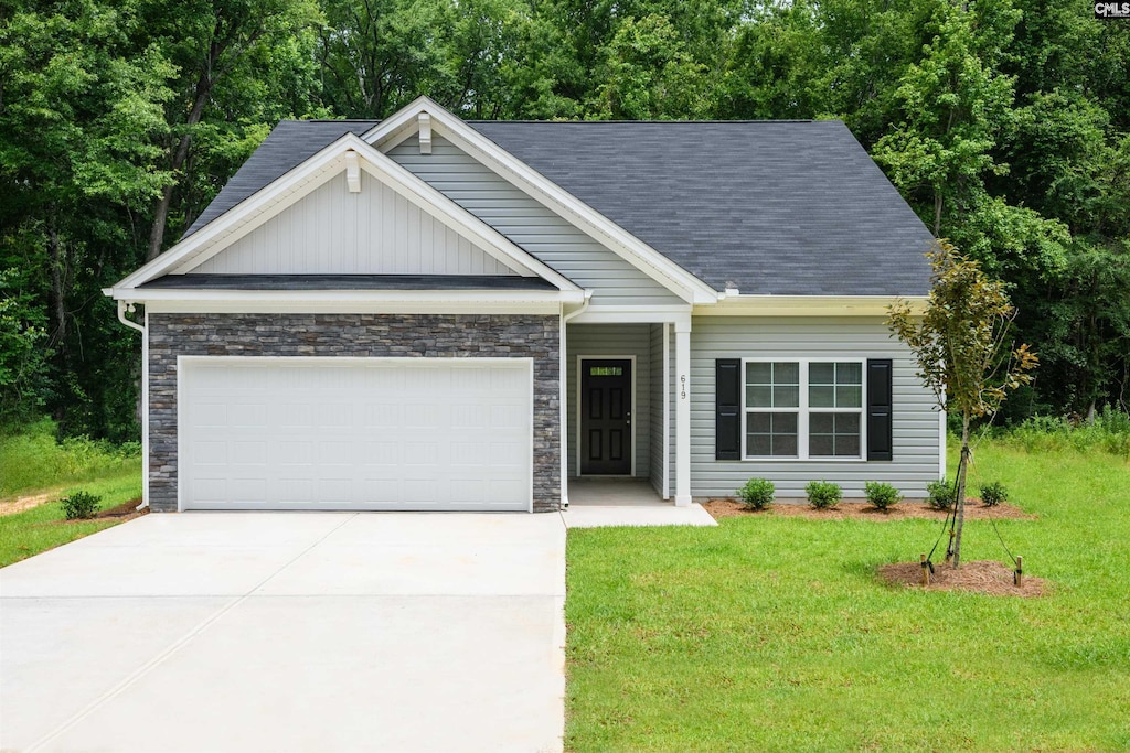 619 Piney Woods Rd, Columbia, SC 29210 - view of front facade featuring an attached garage, a front lawn, concrete driveway, and stone siding