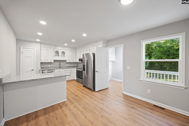 100 Coventry Ct, Lexington, SC 29072 - kitchen featuring appliances with stainless steel finishes, white cabinets, a peninsula, light stone countertops, and recessed lighting