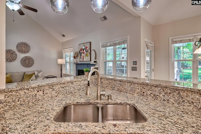 305 W Ashford Way, Irmo, SC 29063 - kitchen featuring vaulted ceiling, light stone countertops, ceiling fan, open floor plan, and a fireplace