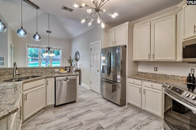 305 W Ashford Way, Irmo, SC 29063 - kitchen featuring appliances with stainless steel finishes, a chandelier, vaulted ceiling, hanging light fixtures, and light stone countertops