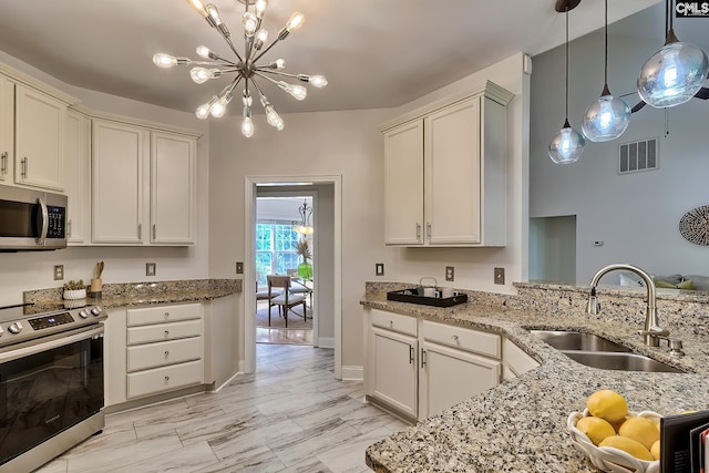 305 W Ashford Way, Irmo, SC 29063 - kitchen with stainless steel appliances, a chandelier, light stone counters, and hanging light fixtures