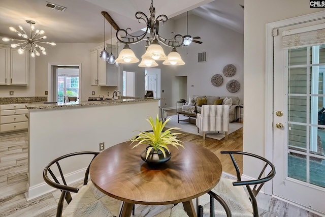 305 W Ashford Way, Irmo, SC 29063 - dining room with a chandelier, high vaulted ceiling, and light wood-style flooring