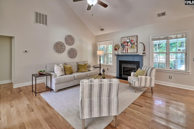 305 W Ashford Way, Irmo, SC 29063 - living room featuring plenty of natural light, high vaulted ceiling, a fireplace with flush hearth, a ceiling fan, and light wood-type flooring