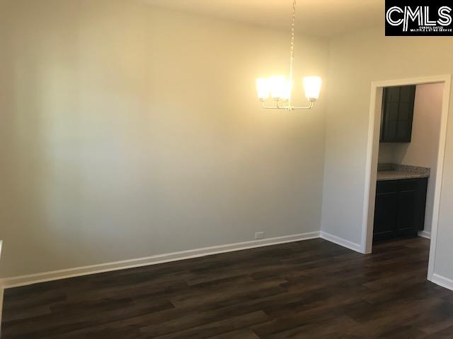 1351 Tamarind Ln, Chapin, SC 29036 - unfurnished dining area featuring a chandelier and dark wood finished floors
