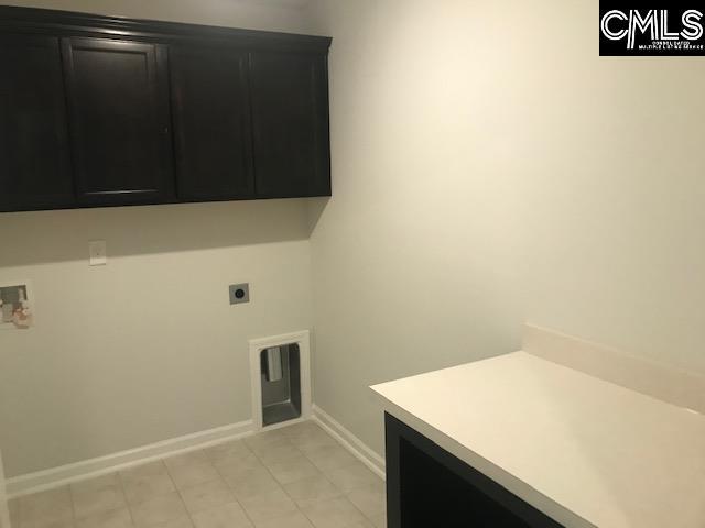 1351 Tamarind Ln, Chapin, SC 29036 - laundry room with cabinet space, electric dryer hookup, light tile patterned floors, and hookup for a washing machine
