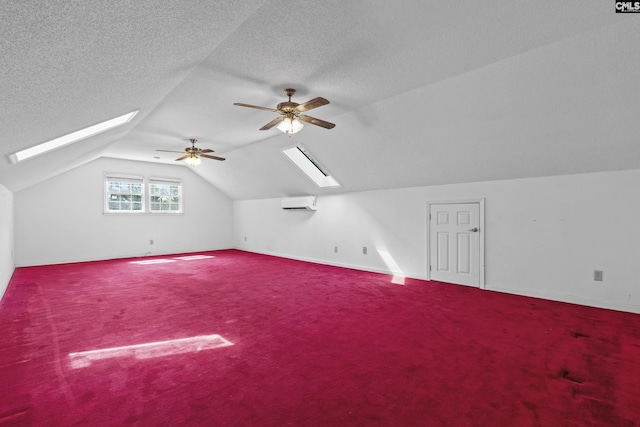 242 Arrow Shores Rd, Chapin, SC 29036 - additional living space featuring a skylight, vaulted ceiling, a ceiling fan, an AC wall unit, and carpet