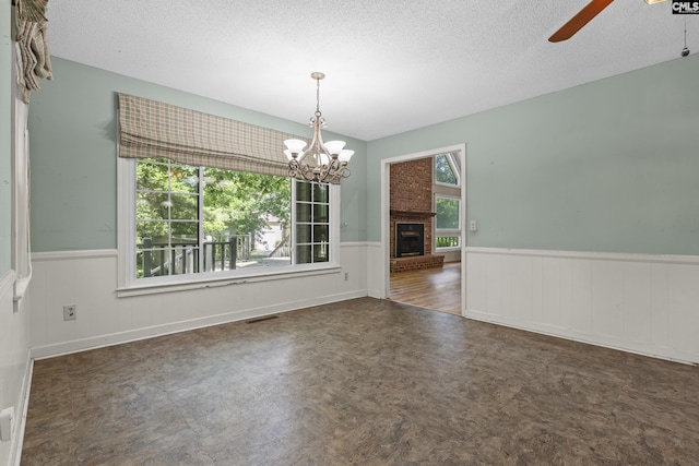 242 Arrow Shores Rd, Chapin, SC 29036 - unfurnished room with a wainscoted wall, ceiling fan, a textured ceiling, a chandelier, and tile patterned floors