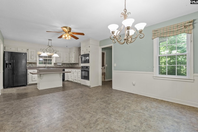 242 Arrow Shores Rd, Chapin, SC 29036 - kitchen with black appliances, white cabinetry, a chandelier, ceiling fan, and wainscoting