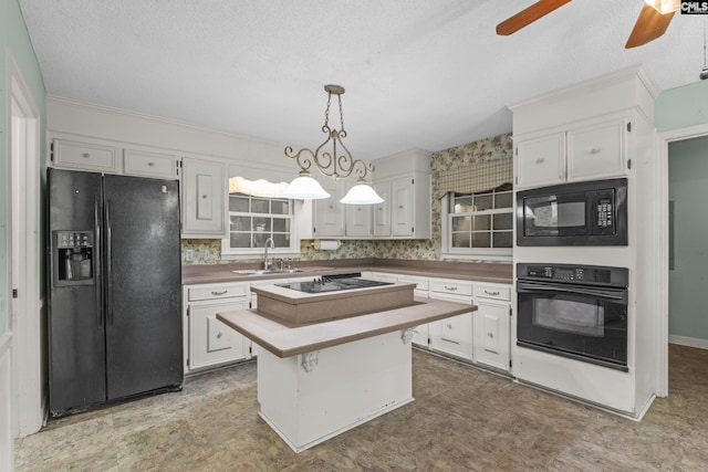 242 Arrow Shores Rd, Chapin, SC 29036 - kitchen with black appliances, white cabinetry, a ceiling fan, pendant lighting, and a center island