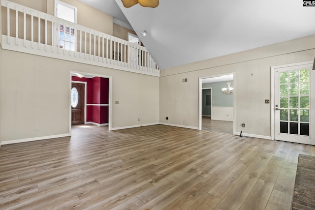 242 Arrow Shores Rd, Chapin, SC 29036 - unfurnished living room with a chandelier, high vaulted ceiling, wood finished floors, and a ceiling fan