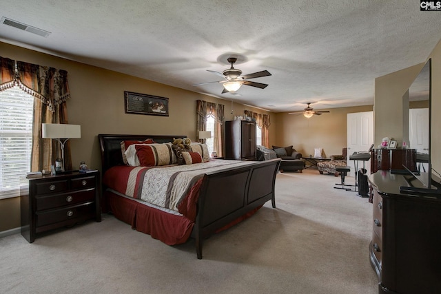 7 Chickasaw Cir, Columbia, SC 29229 - bedroom featuring multiple windows, light colored carpet, a textured ceiling, and a ceiling fan