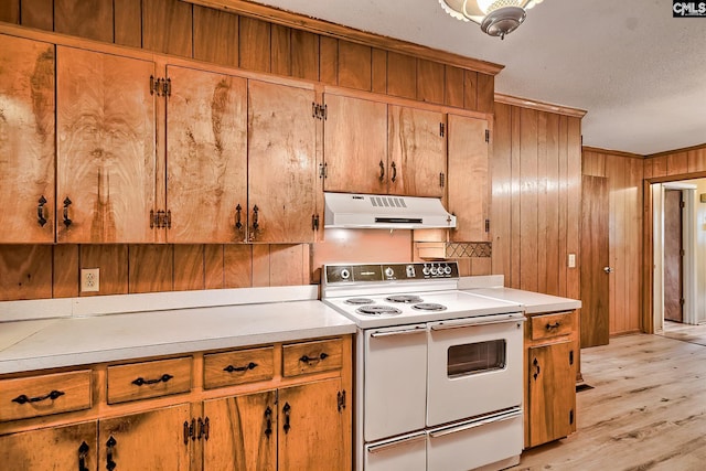 1700 Cermack St, Columbia, SC 29223 - kitchen featuring range with two ovens, under cabinet range hood, light countertops, light wood finished floors, and wooden walls