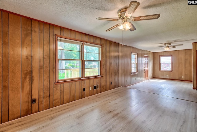1700 Cermack St, Columbia, SC 29223 - spare room with ceiling fan, wood-type flooring, a textured ceiling, and wood walls