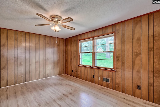 1700 Cermack St, Columbia, SC 29223 - spare room with a ceiling fan, wood finished floors, a textured ceiling, and wood walls