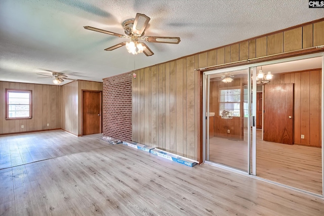 1700 Cermack St, Columbia, SC 29223 - empty room with a ceiling fan, light wood-style floors, a textured ceiling, and wood walls