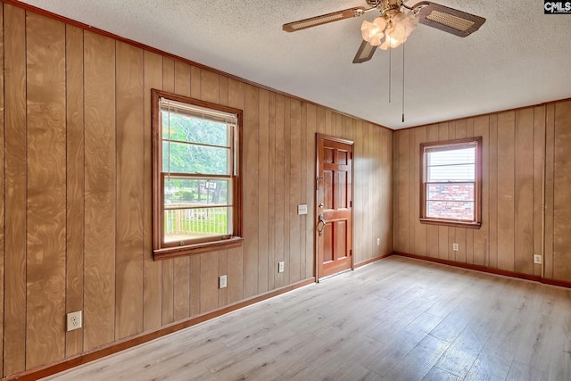 1700 Cermack St, Columbia, SC 29223 - empty room featuring wood finished floors, plenty of natural light, a ceiling fan, a textured ceiling, and wooden walls