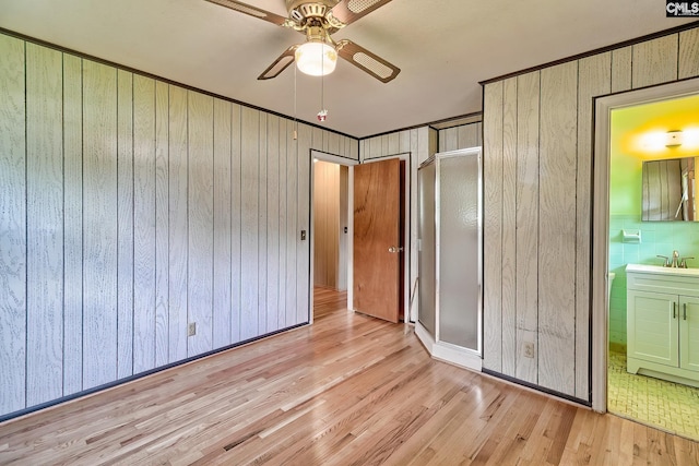 1700 Cermack St, Columbia, SC 29223 - unfurnished bedroom with wood finished floors, wood walls, ensuite bath, and a ceiling fan