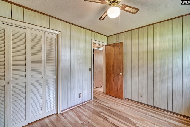 1700 Cermack St, Columbia, SC 29223 - unfurnished bedroom with ornamental molding, a textured ceiling, a closet, light wood finished floors, and wooden walls