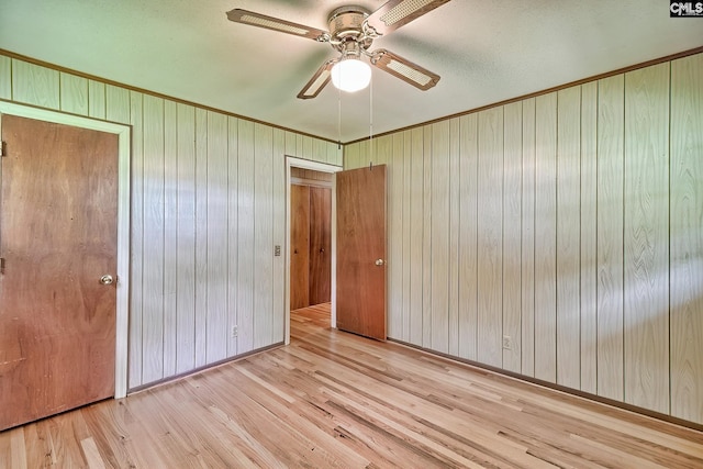 1700 Cermack St, Columbia, SC 29223 - unfurnished bedroom featuring wood finished floors, wood walls, ornamental molding, ceiling fan, and a closet