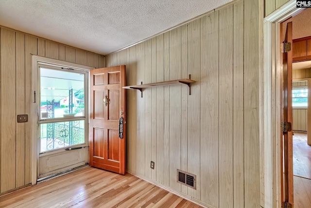 1700 Cermack St, Columbia, SC 29223 - entrance foyer featuring wooden walls, a textured ceiling, and light wood-type flooring