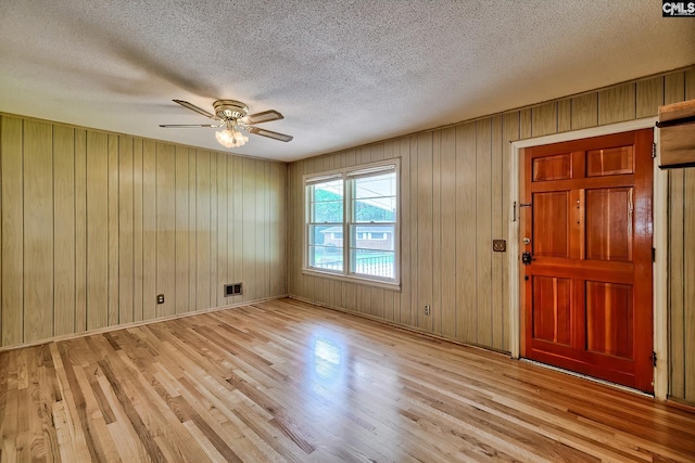 1700 Cermack St, Columbia, SC 29223 - entrance foyer featuring light wood-type flooring, ceiling fan, wooden walls, and a textured ceiling