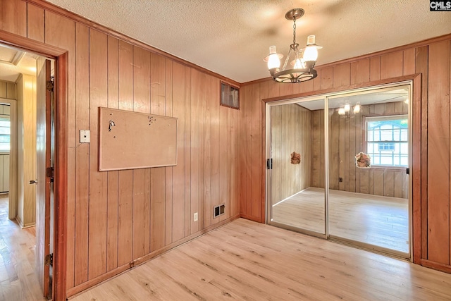 1700 Cermack St, Columbia, SC 29223 - interior space featuring a chandelier, light wood-style floors, wooden walls, a textured ceiling, and crown molding