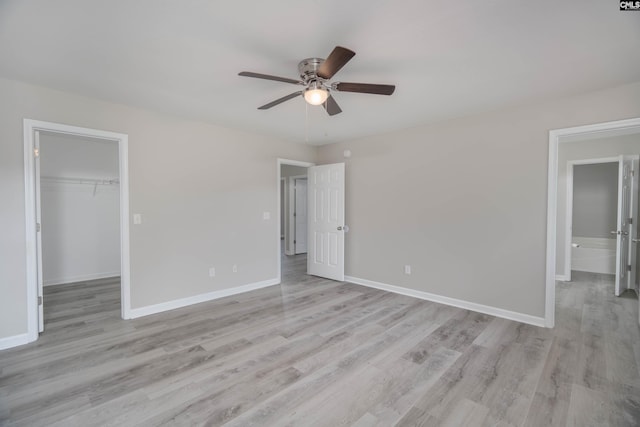 233 Eagle Pointe Dr, Chapin, SC 29036 - unfurnished bedroom with light wood finished floors, a spacious closet, a closet, and ceiling fan