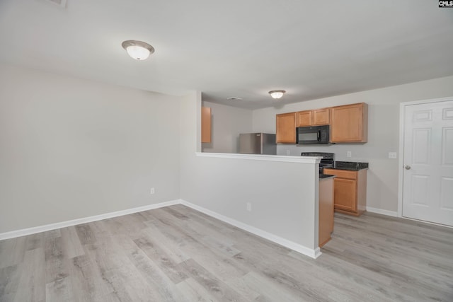 233 Eagle Pointe Dr, Chapin, SC 29036 - kitchen with black appliances, light wood-style floors, a peninsula, and brown cabinetry